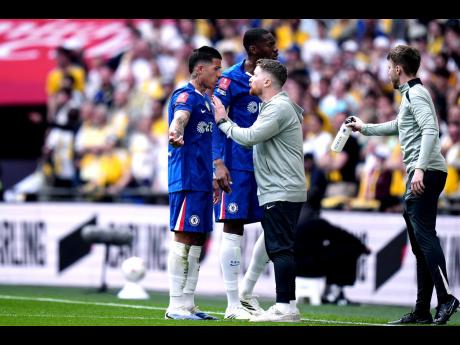 Chelsea’s interim manager Calum McFarlane speaks with goalscorer Enzo Fernandez during the FA Cup semifinal soccer match against Leeds in London, England, on Sunday. Chelsea won 1-0.