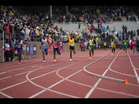 Jamaica College’s Kai Kelly (third left) anchors his team to victory in the boys’ Championships of America 4x100 metres relay at the Penn Relays inside the Franklin Field Stadium in Pennsylvania on Saturday.