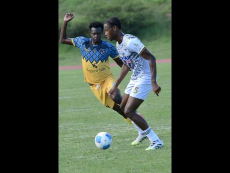 Rudolph Brown/Photographer 
Chavany Shaun Willis (left) of Racing United and Akil Kyel Henry of Cavalier challenge for the ball during the Jamaica Premier League football match at Stadium East on Sunday.