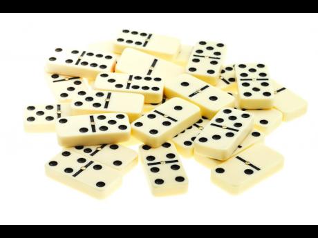 pile of scattered dominoes on isolated white background
