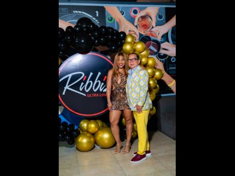 Brian ‘Ribbie’ Chung (right) steps into the spotlight with his significant other, Roshani Howard, at his 67th birthday celebration at Ribbiz Ultra Lounge last Thursday.