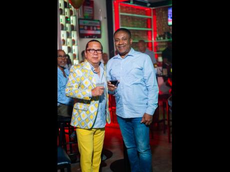 Opposition Spokesman on Energy Phillip Paulwell (right) links up with birthday king Brian ‘Ribbie’ Chung.