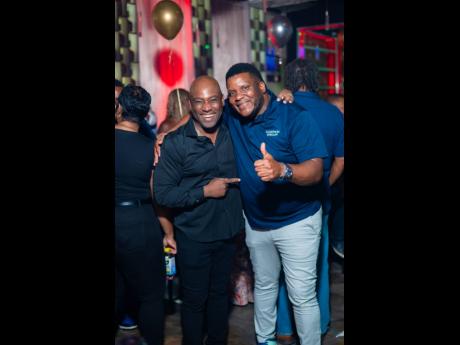 Everton ‘Remy’ Bryan (left), co-owner of Ribbiz Ultra Lounge, and Cecil Smith Jr share a laugh during the high-energy birthday celebration.