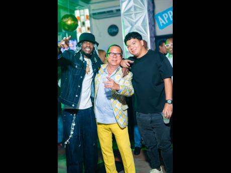 Dancehall artiste Ding Dong (left) links up with birthday boss Brian ‘Ribbie’ Chung (centre) and his son, Tyler.