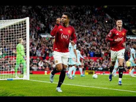 Manchester United’s Casemiro (left) celebrates after scoring, along with teammate Benjamin Sesko, during the English Premier League soccer match against Brentford in Manchester, England, on Monday.