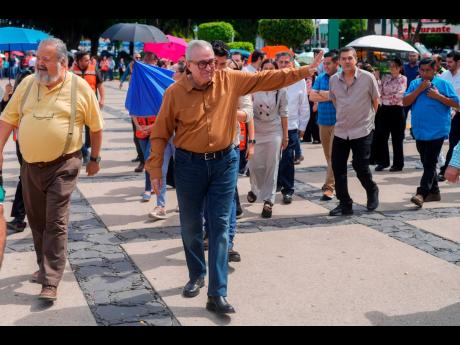 FILE – Sinaloa state Governor Ruben Rocha waves as he takes part in an annual earthquake drill in Culiacan, Mexico. 