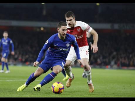  
Chelsea’s Eden Hazard (left) vies for the ball with Arsenal’s Sokratis Papastathopoulos during their English Premier League match at the Emirates Stadium in London on Saturday, January 19.